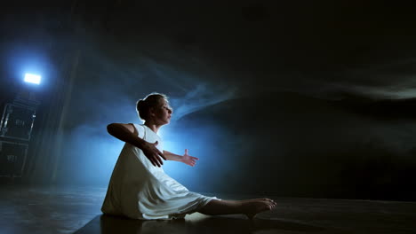 Woman-in-white-dress-on-stage-with-smoke-dancing-modern-ballet